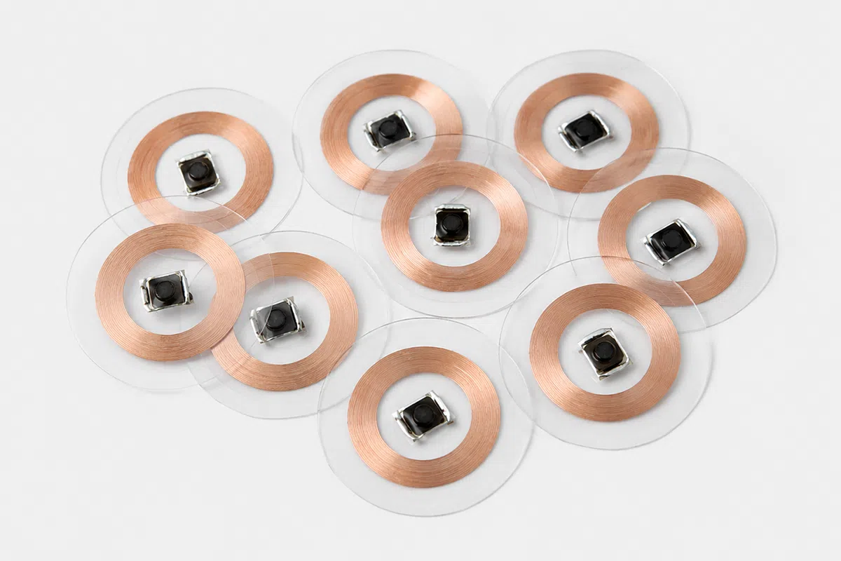 Transparent LF RFID film token for low-profile identification